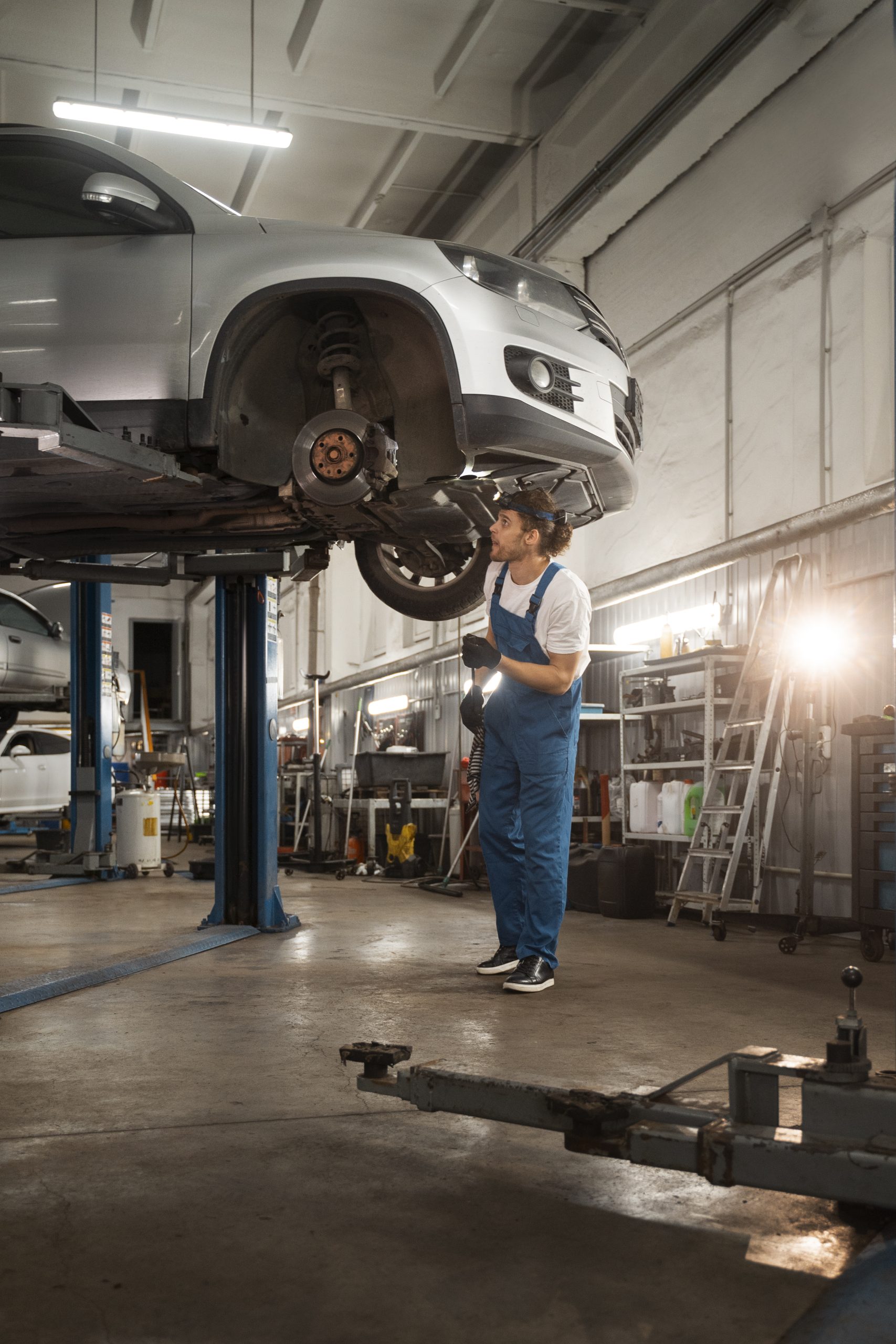 male mechanic working shop car